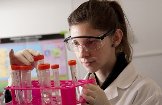 female scientist holding test tube rack