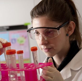 female scientist holding test tube rack 