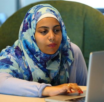 female student looking at laptop 