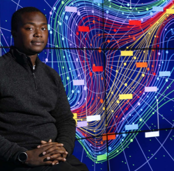 male sitting in front of colorful data map 